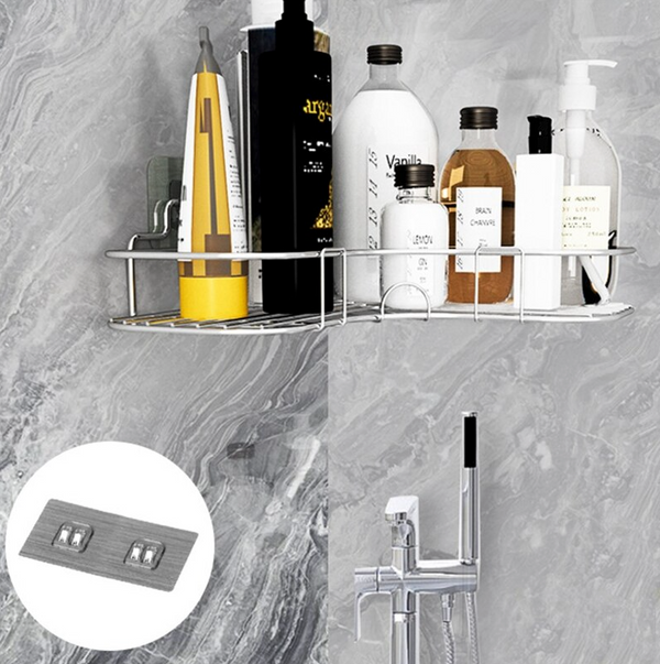 Stainless steel corner shower caddy holding bottles on a marble-look shower wall